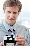 Businessman consulting a business card holder in the office