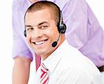 Portrait of a smiling businessman with headset on against white background