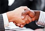 Close-up of a handshake between two businessmen in the office