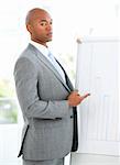 Portrait of a charismatic businessman pointing a white board  in a meeting