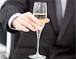 Close-up of a businessman celebrating an event with champagne in the company