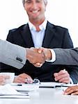 Close-up of a handshake between two businesspeople in front of the boss in the office