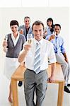 Multi-ethnic business people toasting with Champagne in the office