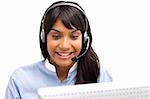 Positive ethnic customer service representative using headset in a call center