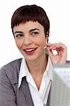 Assertive businesswoman with headset on against a white background