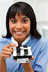 Smiling businesswoman searching for the index in the office