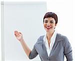 Assertive young businesswoman ponting at a board against a white background