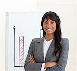 Afro-american businesswoman with folded arms in front of a board against a white background
