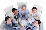 High angle of positive business people holding a terrestrial globe in a meeting