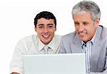 Charming business co-workers using a laptop against a white background