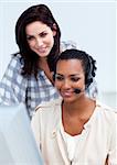 Confident businesswoman with headset on working at a computer