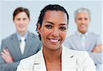 Charismatic afro-american businesswoman standing in front of her team