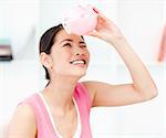 Portrait of a smiling businesswoman holding a piggy-bank in the office