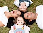 Positive family lying on the floor together outdoor