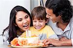 Positive family celebrating a birthday together at home