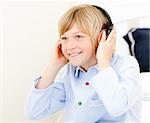 Adorable boy listenning music in a bedroom