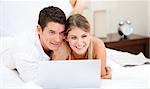 Positive couple surfing on the internet at home