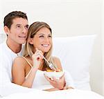 Bright couple having breakfast against a white background