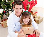 Handsome father celebrating christmas with his daughter at home