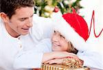 Attractive father celebrating christmas with his son at home