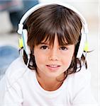 Smiling boy listenning music in a bedroom