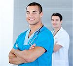 Handsome male doctor looking at the camera in the hospital