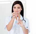 Portrait of a beautiful female doctor preparing a syringe in a hospital