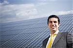 Portrait of mid adult italian businessman in solar power station, smiling at camera. Horizontal shape, front view. Copy space