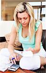 Caucasian woman doing accountancy at home