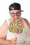 Fat man with thick glasses licking a lollipop