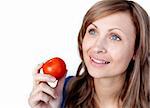 Positive woman holding a tomato isolated on a white background