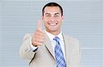 Cheerful businessman with a thumb up in the office