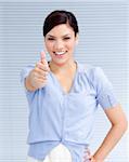 Happy businesswoman with a thumb up at work