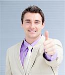 Positive businessman with a thumb up in the office