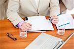 Close-up of a businessman working in a meeting with his team