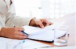 Close-up of a businessman studying a contract in a meeting