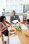 Afro-american family dining together in the kitchen