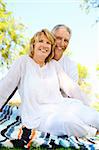 Lifestyle portrait of a mature couple smiling. Focus on the woman.