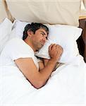 Pensive man lying in the bed after having an argument