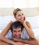 Portrait of a smiling couple lying on the bed