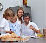 Joyful family having breakfast in the kitchen