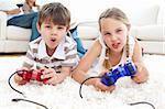 Animated children playing video games lying on the floor