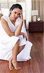 Angry woman sitting on the bed after having a row with her husband