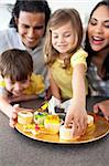 Joyful family eating cookies  in the kitchen