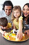 Jolly family eating cookies  in the kitchen