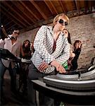 Handsome DJs playing music at a 1970s Disco Music Party