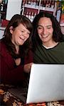 Interracial couple on a laptop at a coffee house