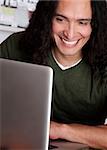 Smiling Native American male working on a laptop