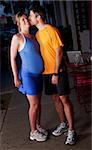 Pregnant woman and husband in fitness attire on the street