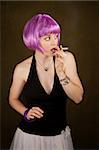 Portrait of woman with shiny purple hair caught smoking